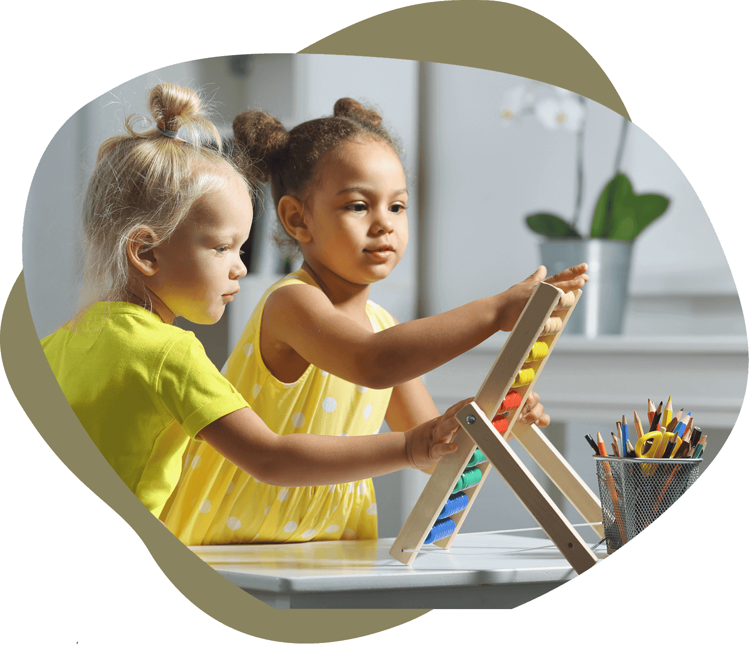 Two young girls painting together on canvases indoors.